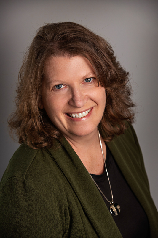 Lori Frederic headshot in green sweater
