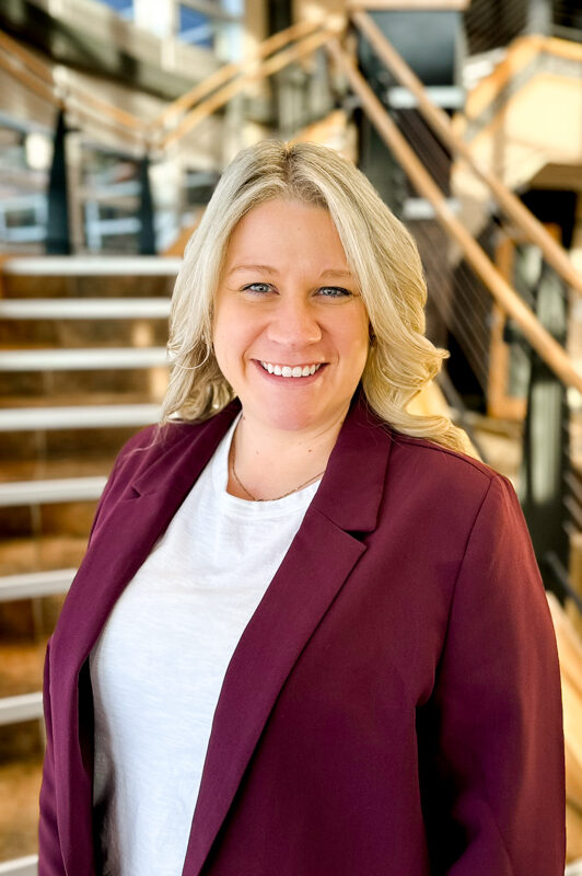 Matty Kerr headshot standing in front of stairs
